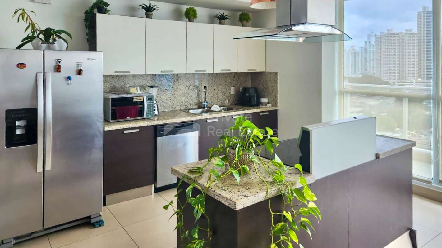 Luxury kitchen with granite island stainless appliances and skyline views at PH Oceania Punta Pacifica Panama