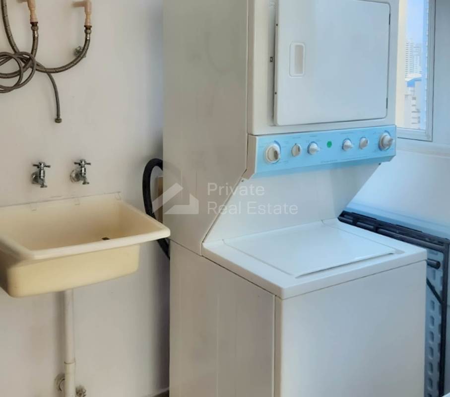 Laundry area with washer dryer, utility sink and ocean backdrop at PH Oceania Tower Punta Pacifica