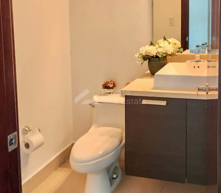 Bedroom with mounted TV large window and ocean backdrop in PH Oceania Tower Panama