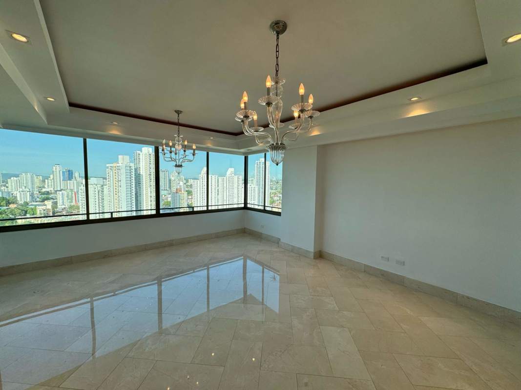 Spacious open living dining zone with chandeliers and skyline view at PH Golf Tower Altos del Golf Panama