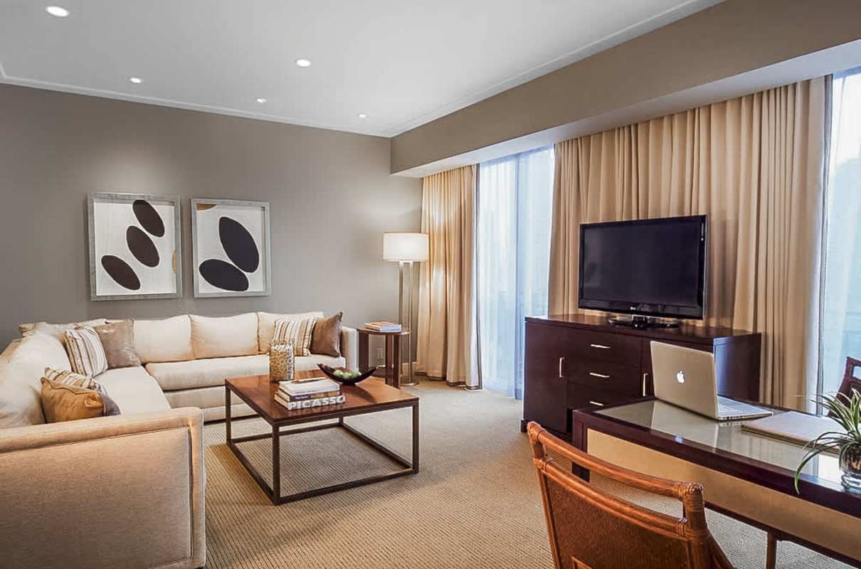 Open dining and living area with striped chairs, large windows PH Bristol Panama