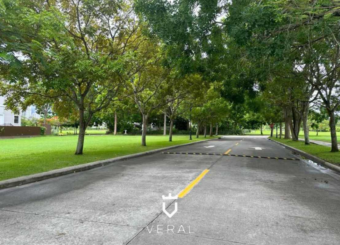 Entrance road lined with greenery within luxury golf residence Santa María Panama