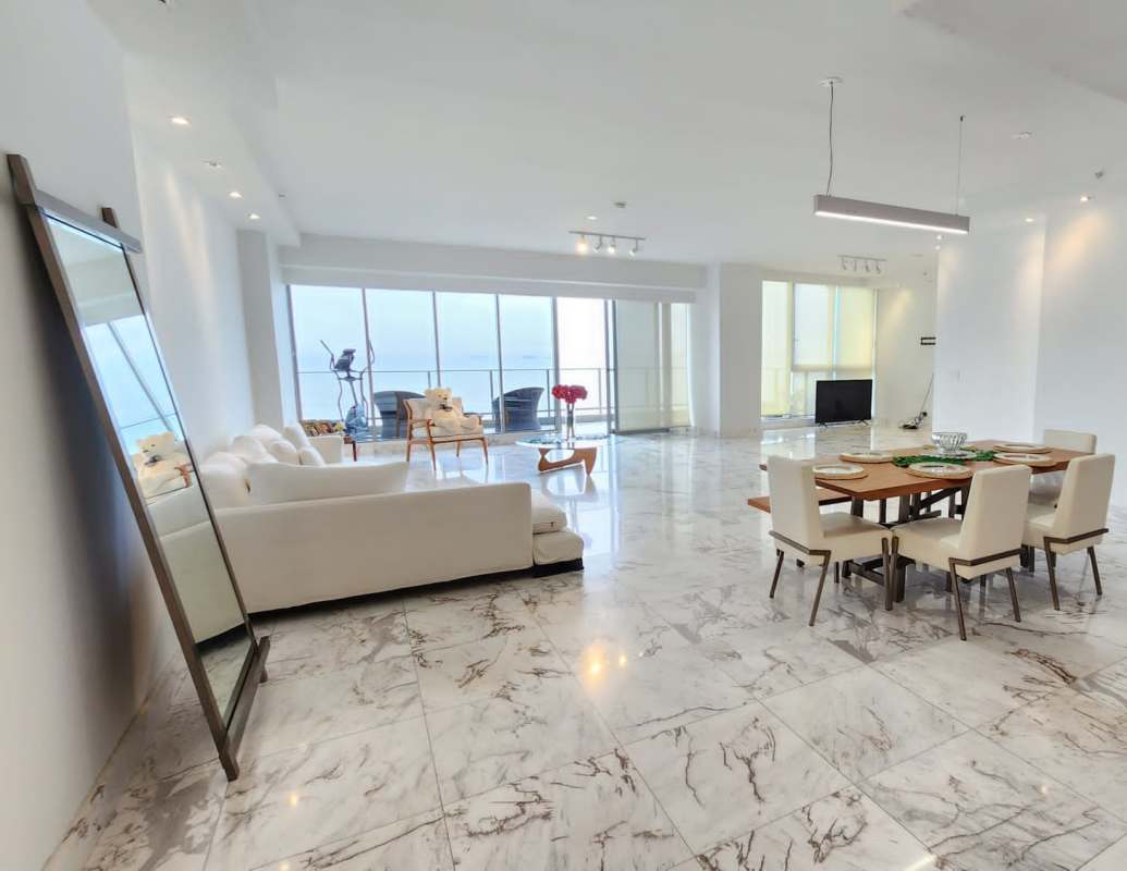 Spacious kitchen with island, wood cabinetry, stainless steel appliances, and large window at PH Mirador Costa del Este