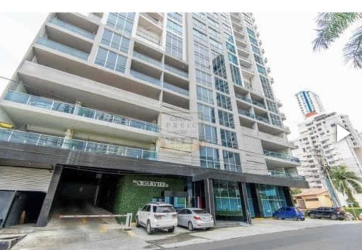 Modern condominium tower with balconies and secure parking entrance Quartier 74 San Francisco Panama