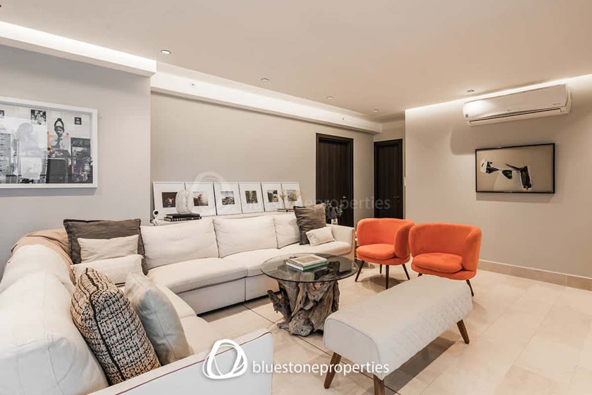 Open modern kitchen with breakfast bar and adjacent dining space in Panama City