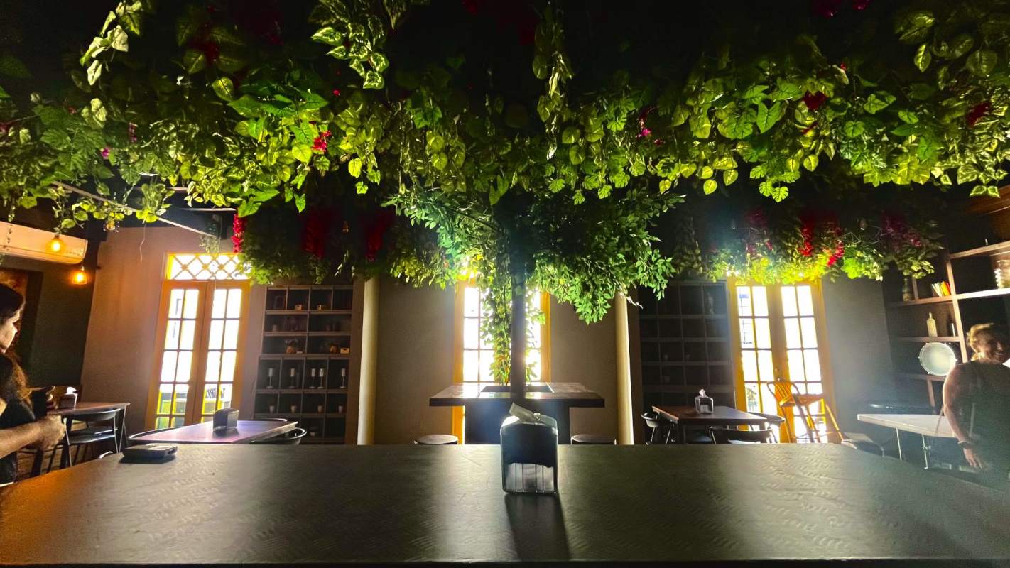 Modern eclectic bathroom with neon sign and greenery in Casco Viejo Panama City