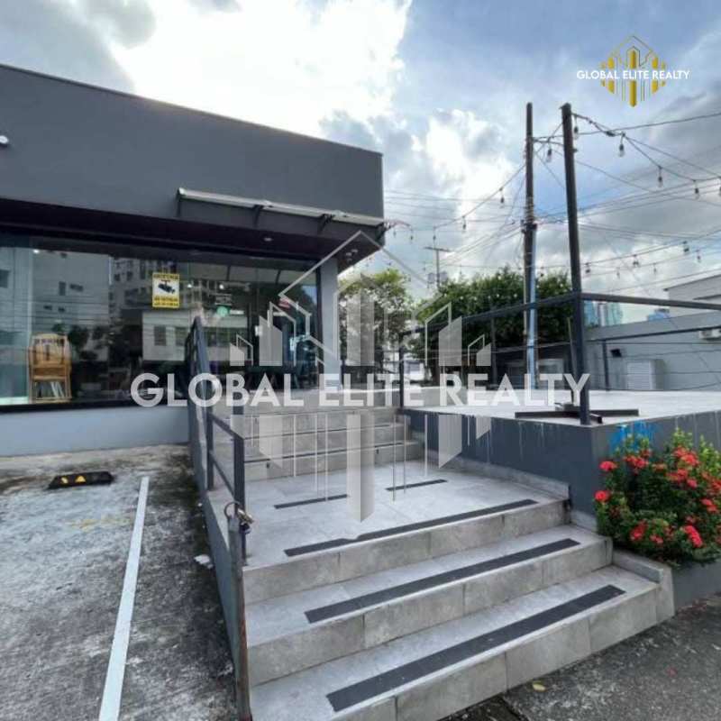 Glass storefront elevation of commercial retail property with signage and parking Via Porras Panama