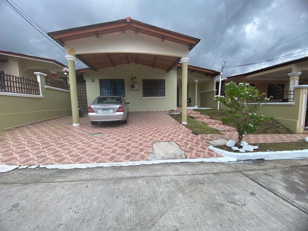 Front of detached single-story house with carport and garden in Brisas del Golf Panama City for sale