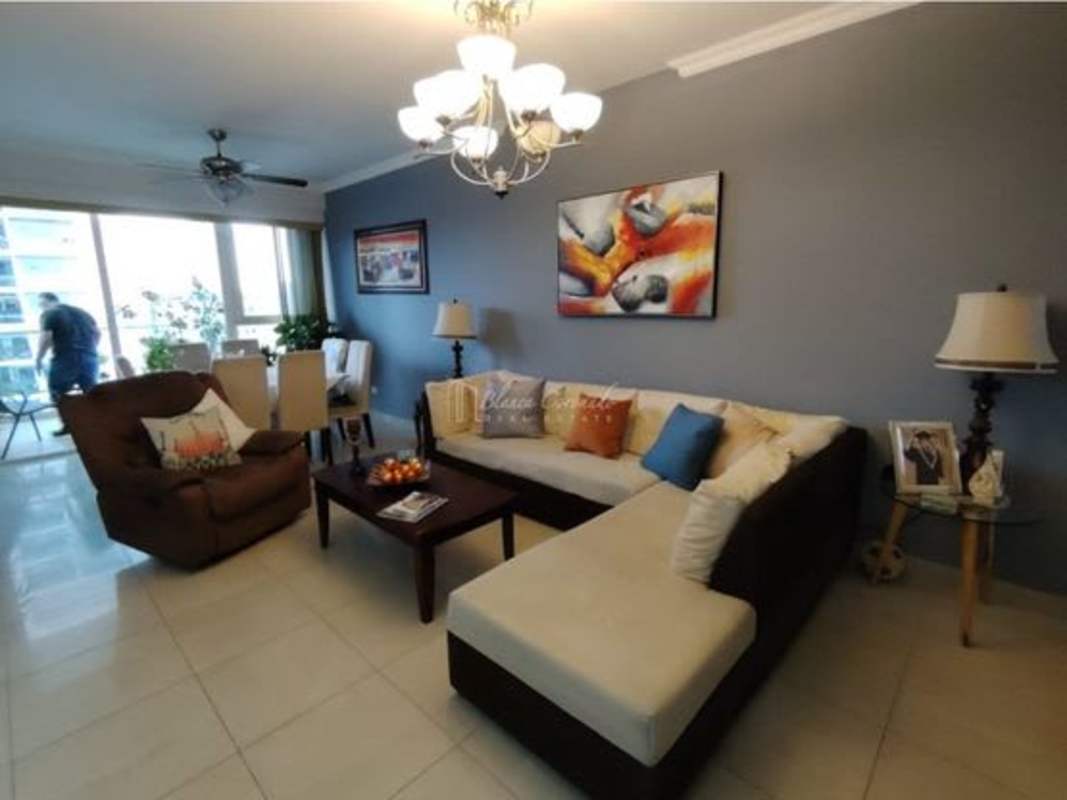 Modern living room with sofa, chandelier, balcony access PH Windows Tower Panama City