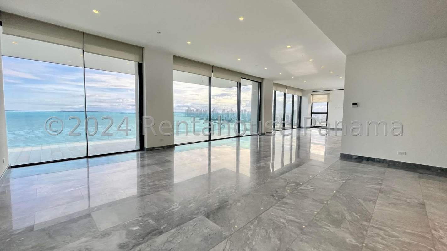 Bright modern living room with floor-to-ceiling glass and ocean view in Upper East Tower, Costa del Este, Panama