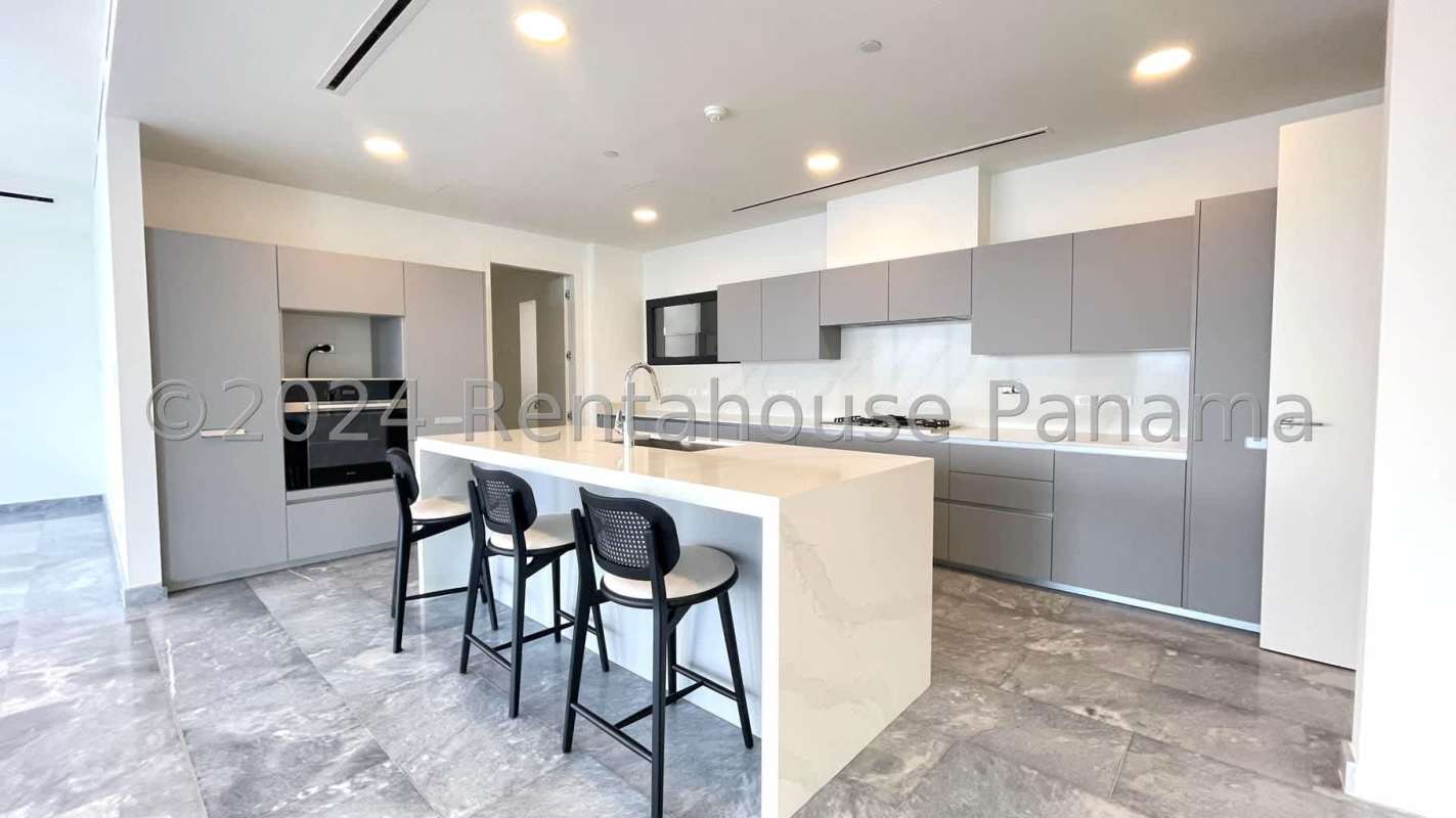 Contemporary Italian kitchen with island marble countertops built-in appliances in Upper East Tower Costa del Este Panama