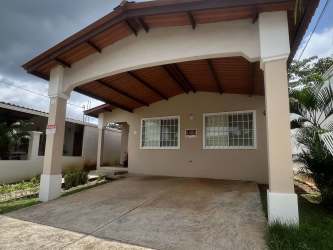 Single-story house with covered parking, secure windows, and driveway in Brisas del Golf Arraiján Panama