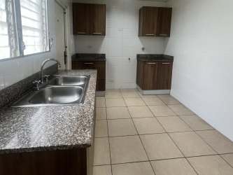 Kitchen with granite countertop, stainless double sink, wood cabinets in Brisas del Golf Arraiján