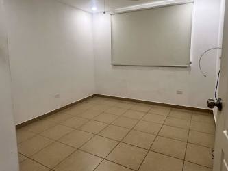 Empty room with white walls, tiled floor, window blind in Brisas del Golf Panama