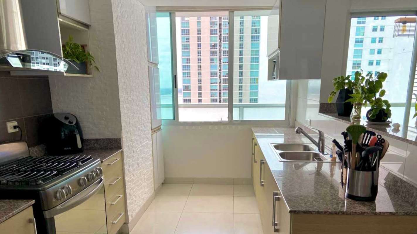 Furnished living room with large windows and ocean view in PH Moon Tower Coco del Mar Panama