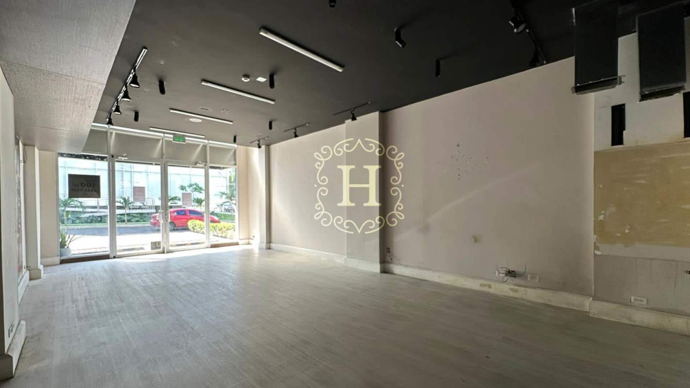 Modern empty commercial space with large glass doors, black ceiling, and light flooring in San Francisco Panama shopping plaza