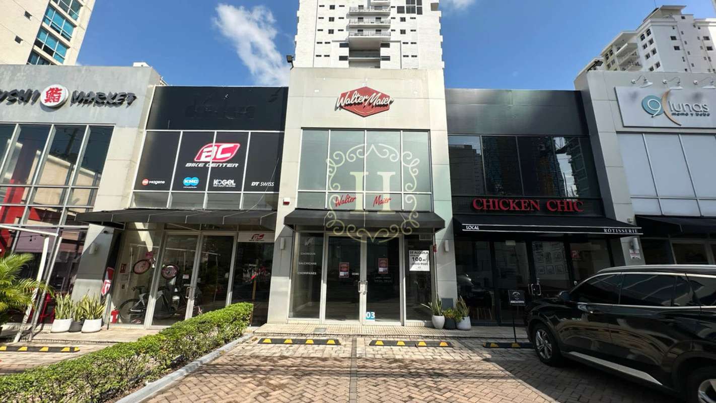 Empty modern retail or commercial office unit with wood floors, neutral decor and black accent wall San Francisco Panama