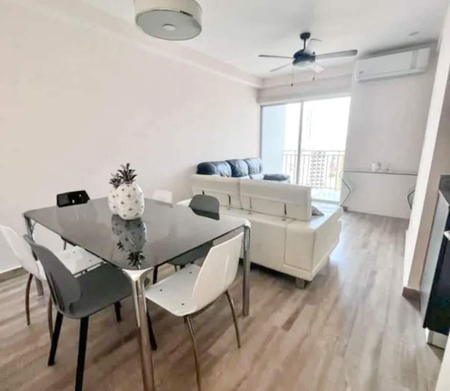 Bright open-concept living and dining room fully furnished with city views at PH El Doral Panama