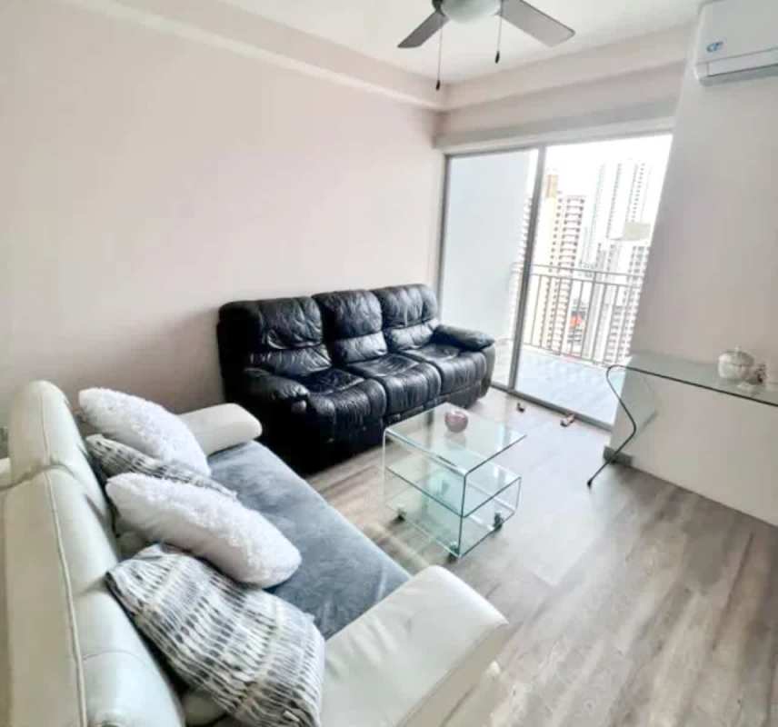 Living room area with access to balcony overlooking city Panama City PH El Doral