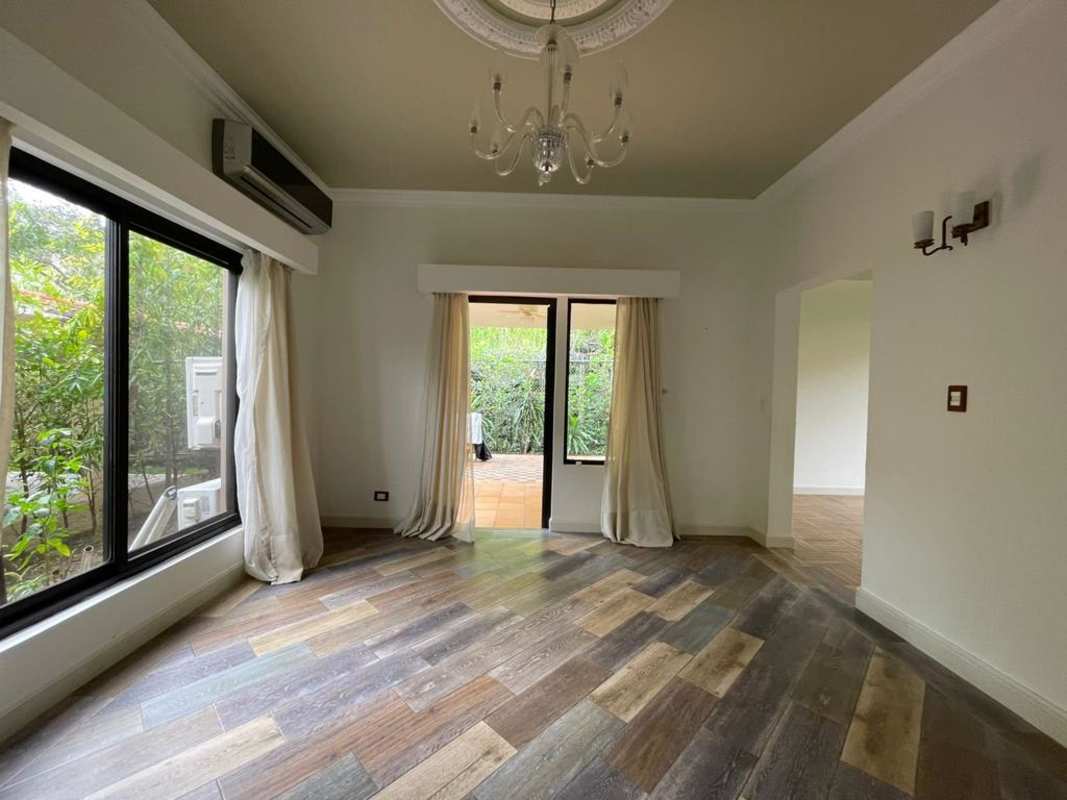 Spacious bright living room with glass doors to garden and chandelier Embassy Club Clayton