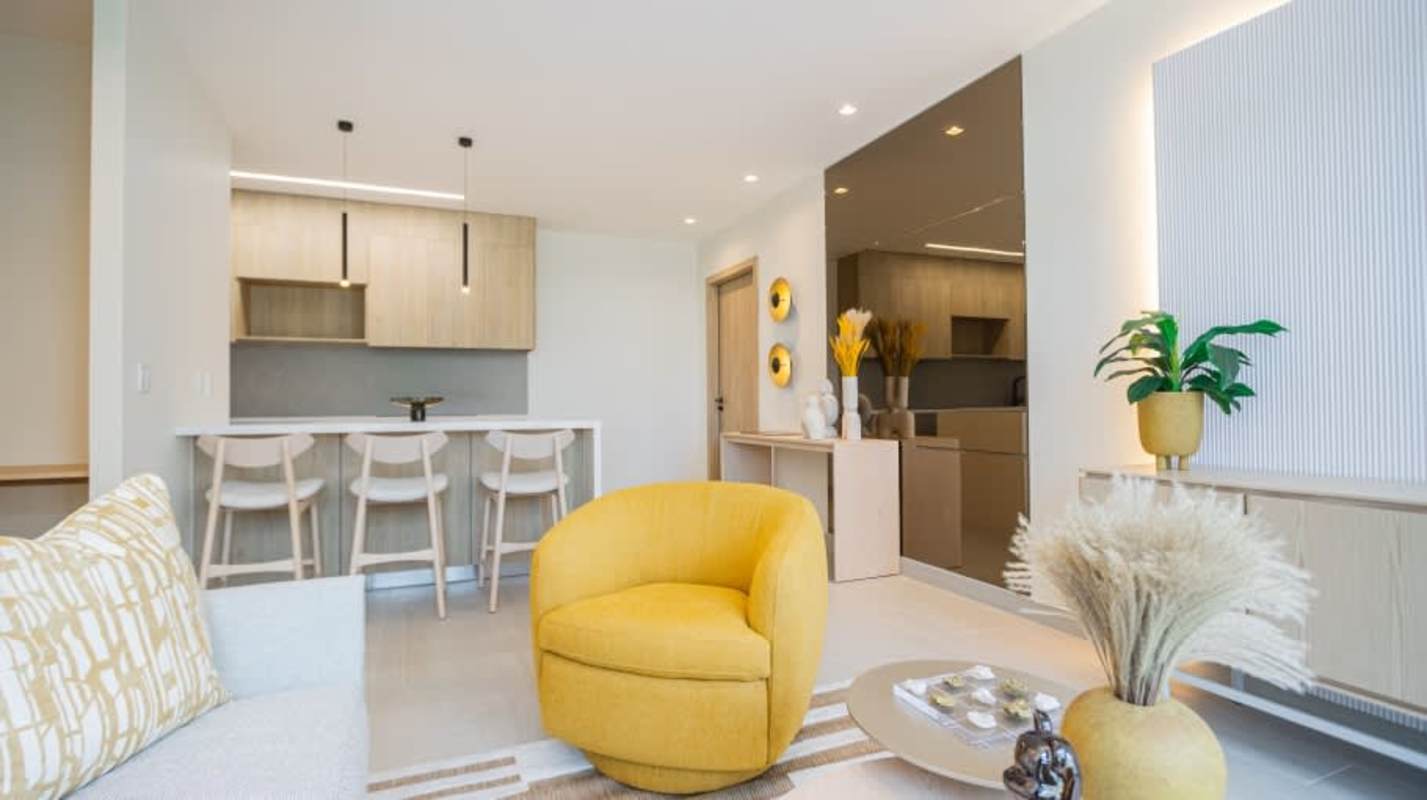 Modern open plan living room kitchen with balcony access at PH Nogal Costa del Este Panama