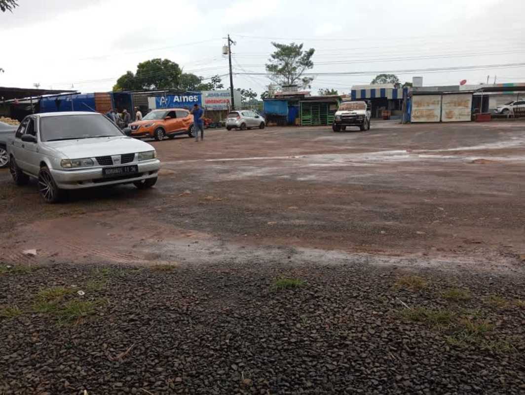 Unpaved parking lot with shops background in commercial central La Chorrera Panama