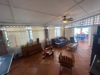 Rustic kitchen with blue cabinets tile counters terrace access beach house PH Villas del Farallón Panama