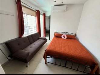 Bedroom furnished with queen bed, ceiling fan, AC unit and blackout curtains in Playa Corona Panama
