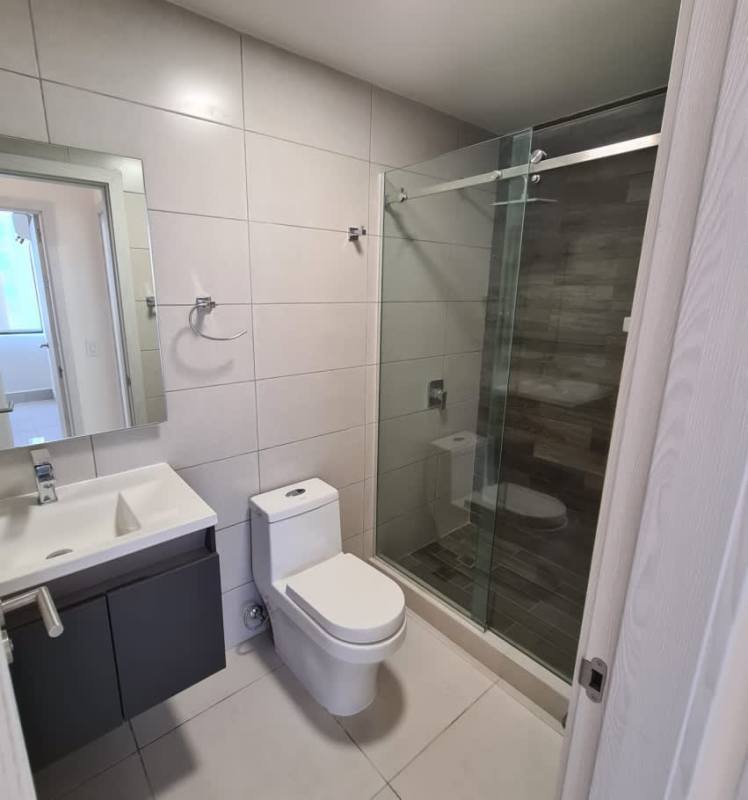 Modern bathroom with glass shower, contemporary sink, tile wall at PH Riverside Panama