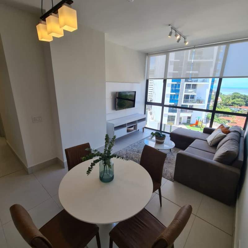 Elegant living and dining area with large windows, ocean views, modern decor in PH Riverside Panama