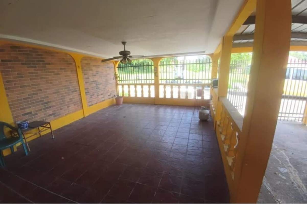 Bedroom in Cerro Viento house with built-in closet, window, and tiled floor Panama City.