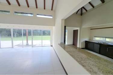 Bright open living with vaulted ceiling, sliding doors, exposed beams in beach villa Decameron Panama