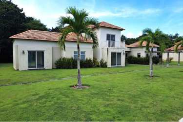 Two-level beach villa with terracotta roof, manicured lawns, balconies at Villas Decameron Panama