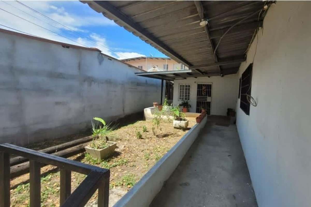 Covered exterior patio and walkway with garden area duplex property Ciudad Radial Panama City