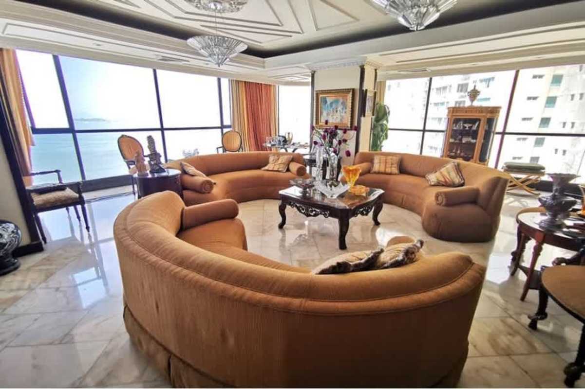 Large penthouse master bedroom with city and ocean views featuring marble floors, fine wood finishes, and large windows
