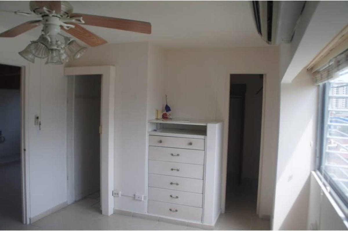 Kitchen with cabinets and adjacent laundry space in PH Park View El Dorado Panama