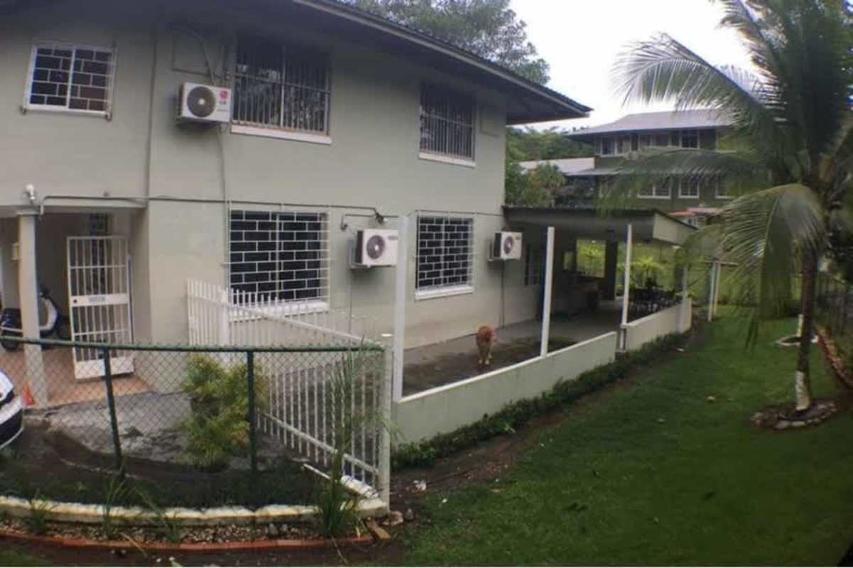 Modern renovated bathroom with double sinks, tile walls and large mirror in Ancón house Panama City