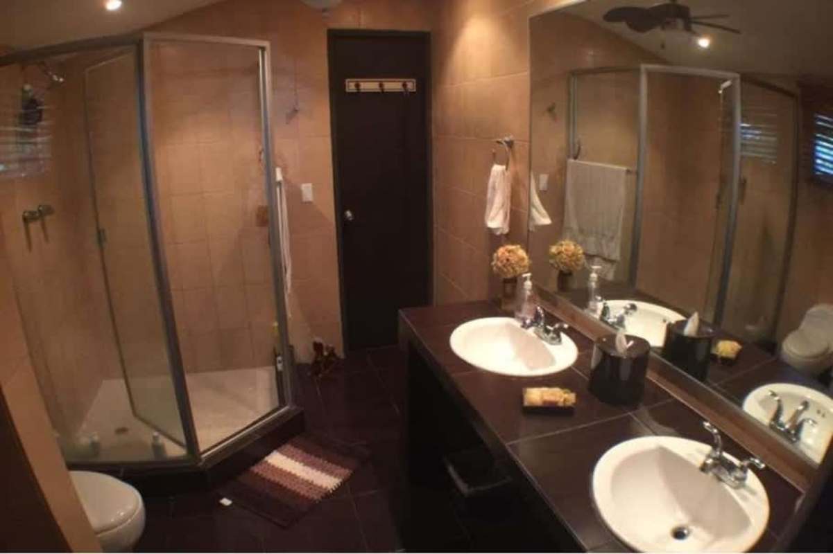 Spacious bedroom with large bed, tiled floors, AC in house for sale Diablo Ancón Panama