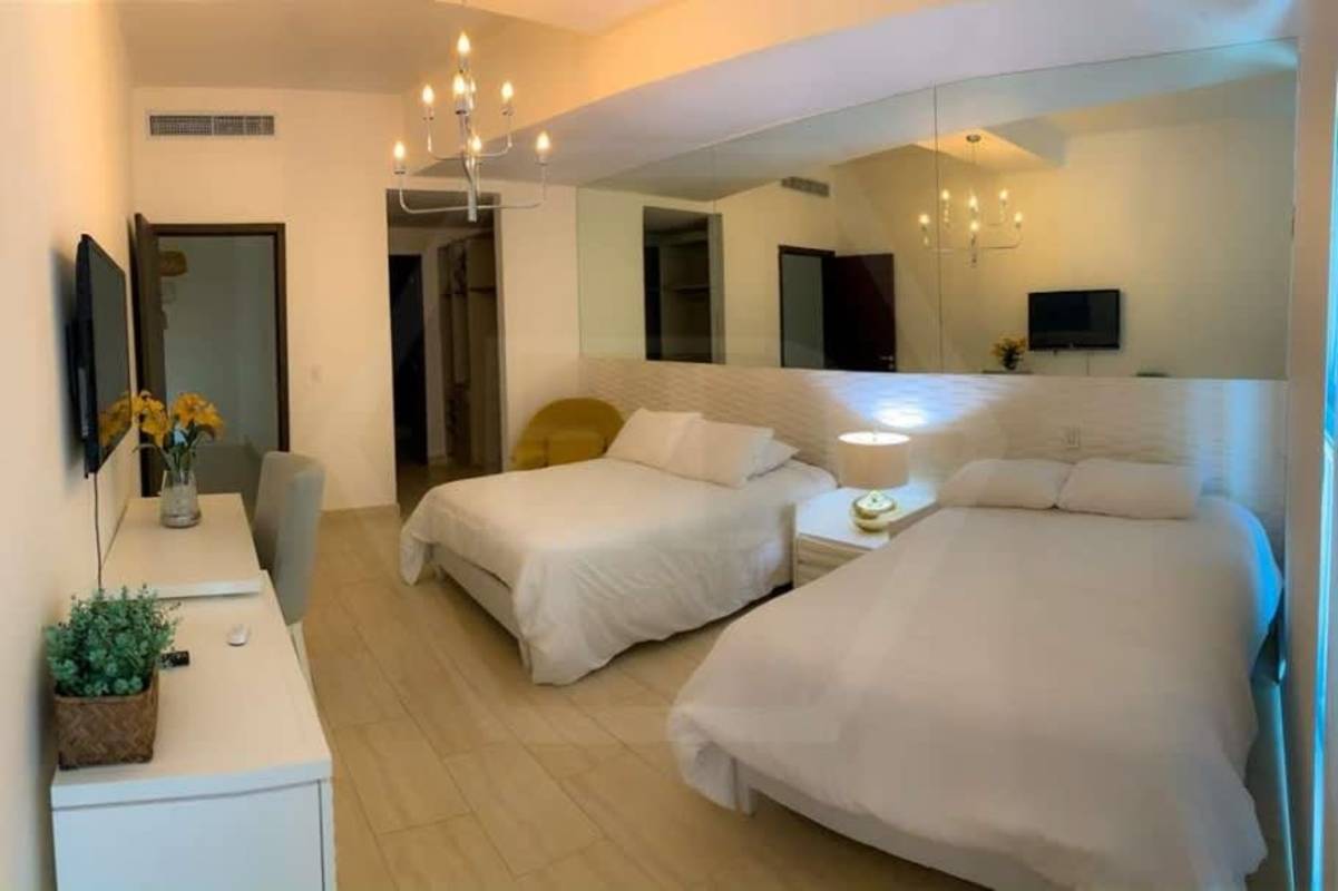 Second bedroom furnished with city skyline views in Grand Tower Punta Pacifica