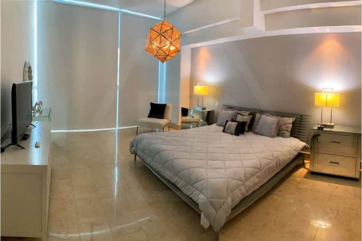 Large master bedroom with king bed, ocean views, high windows at Grand Tower Panama