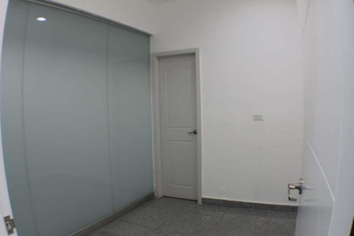Minimalist closet with frosted sliding door inside office PH BICSA Financial Center Panama