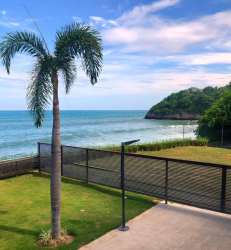 Bright living and dining space with large window ocean views at The Palms San Carlos Panama