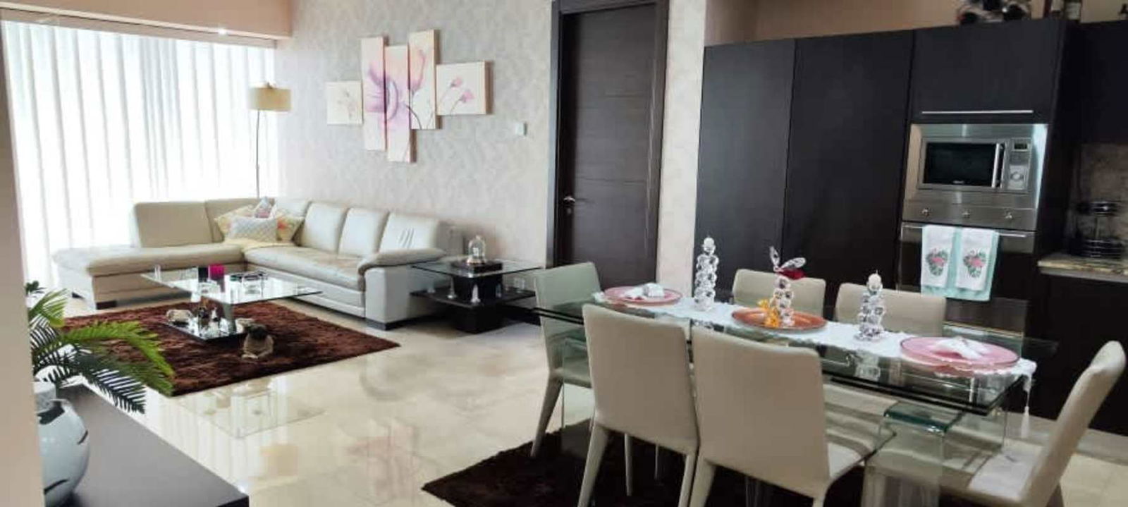 Modern open plan living and dining with balcony access and Pacific Ocean views