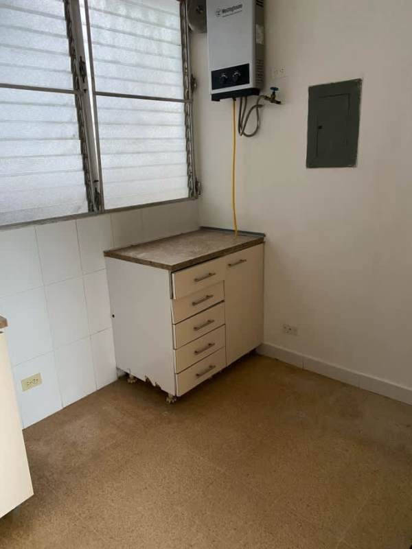 Spacious living room with large windows and tile flooring in Parque Lefevre apartment