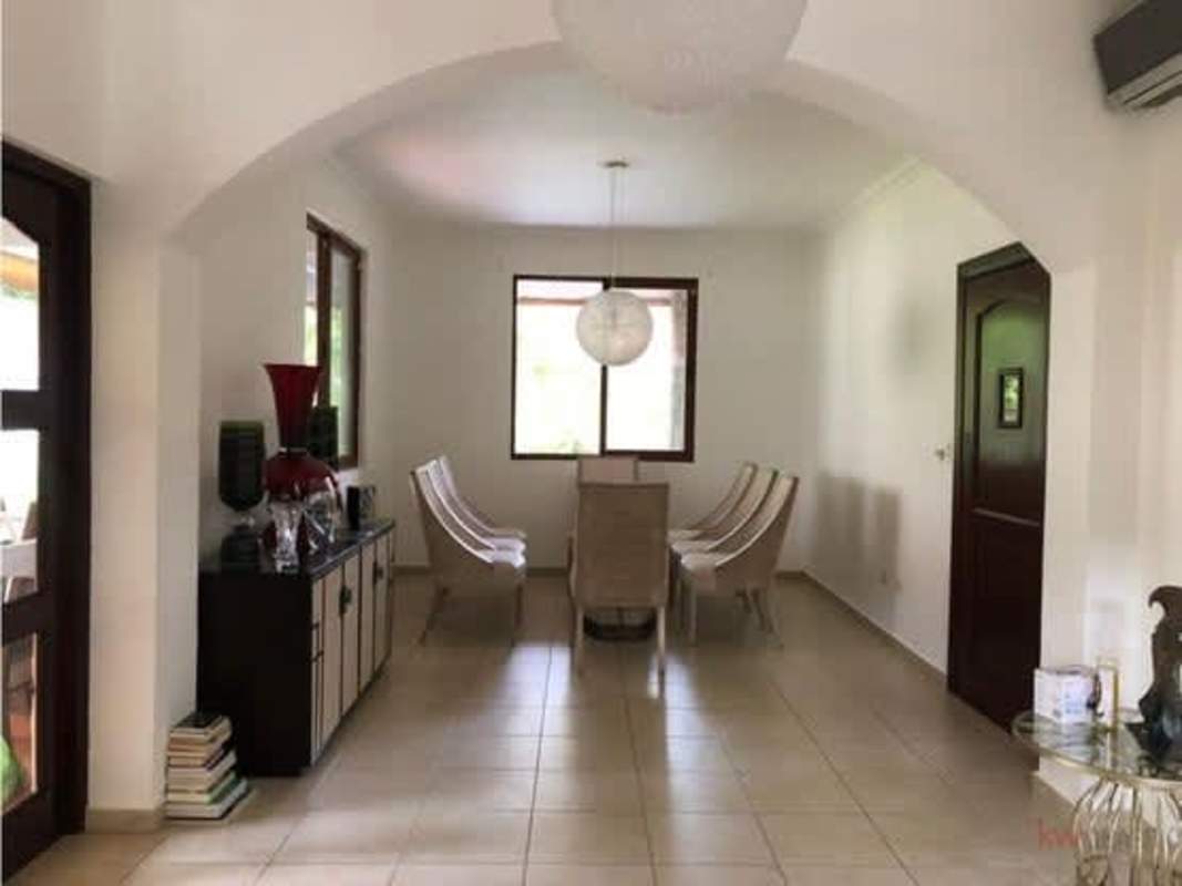 Dining room with arched doors pendant lights in luxury Clayton house Panama