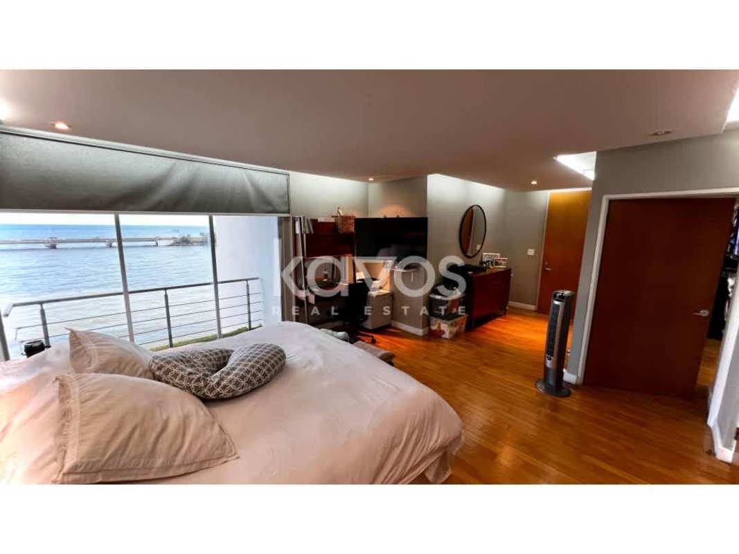 Bedroom with large window and panoramic ocean view in PH Las Llamas apartment Panama