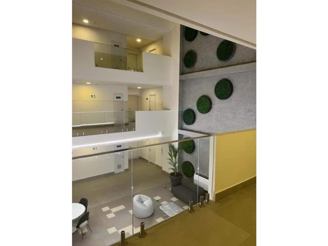 Living area with sectional sofa, dining table, AC, large windows in PH Coco Place Coco del Mar