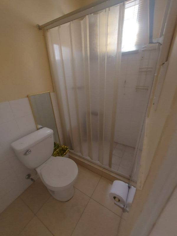 Bedroom with orange walls, bunk bed, double bed, closet and garden view window in Golden Springs