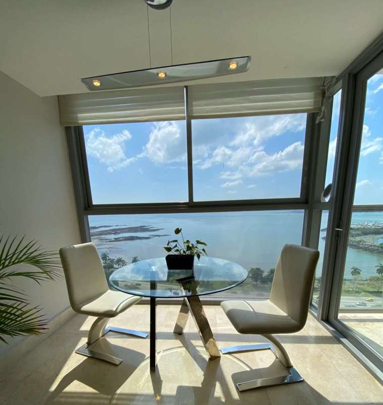 Modern dining room with large windows and ocean view at PH BICSA Panama City