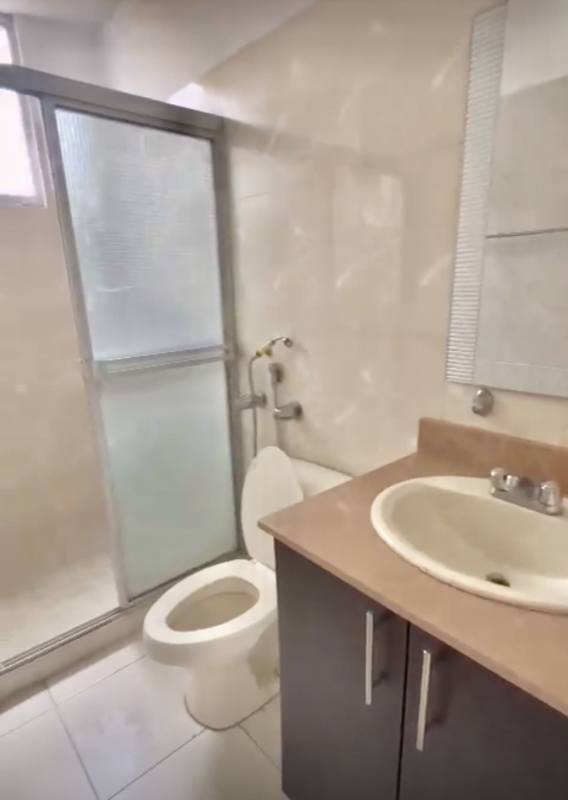 Modern bathroom with glass shower and white vanity in PH Montemar San Francisco Panama